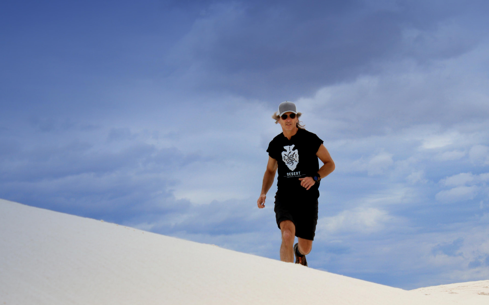 Jon Sabes running across White Sands dunes